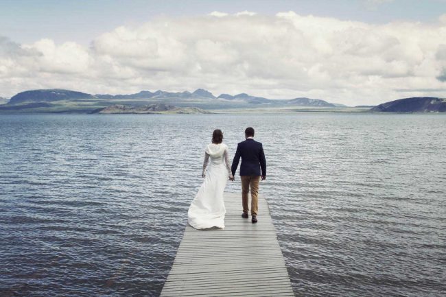 Happy married couple on a bridge in Iceland