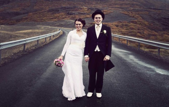 Happy married couple on a road in Iceland