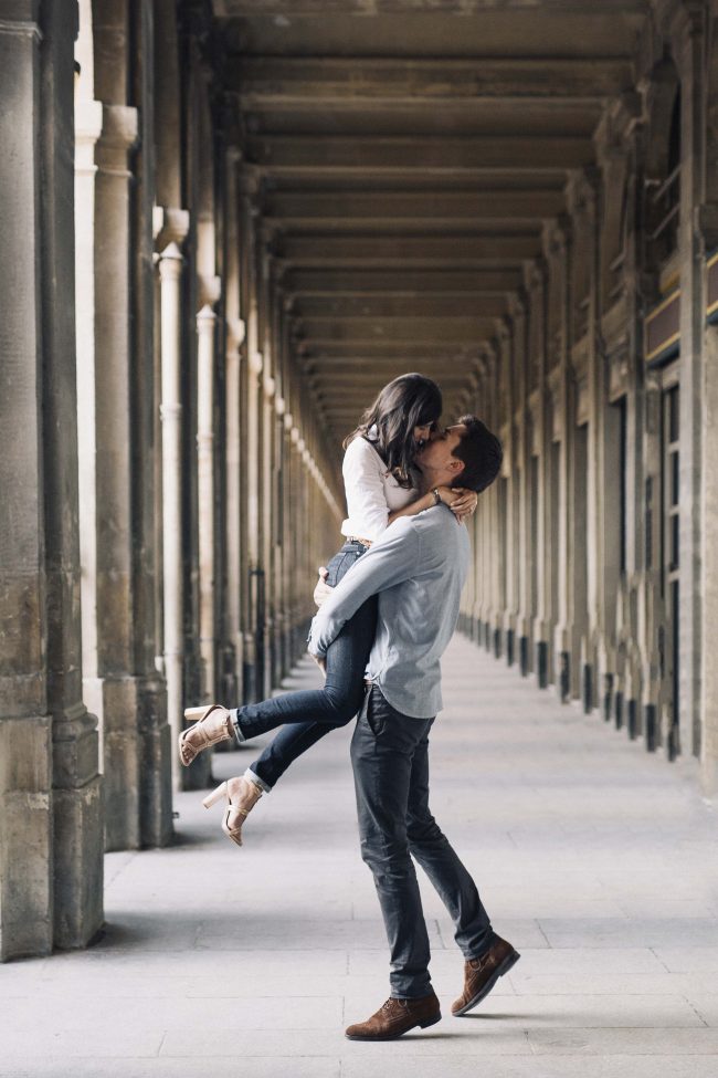 Engaged couple kissing in Paris